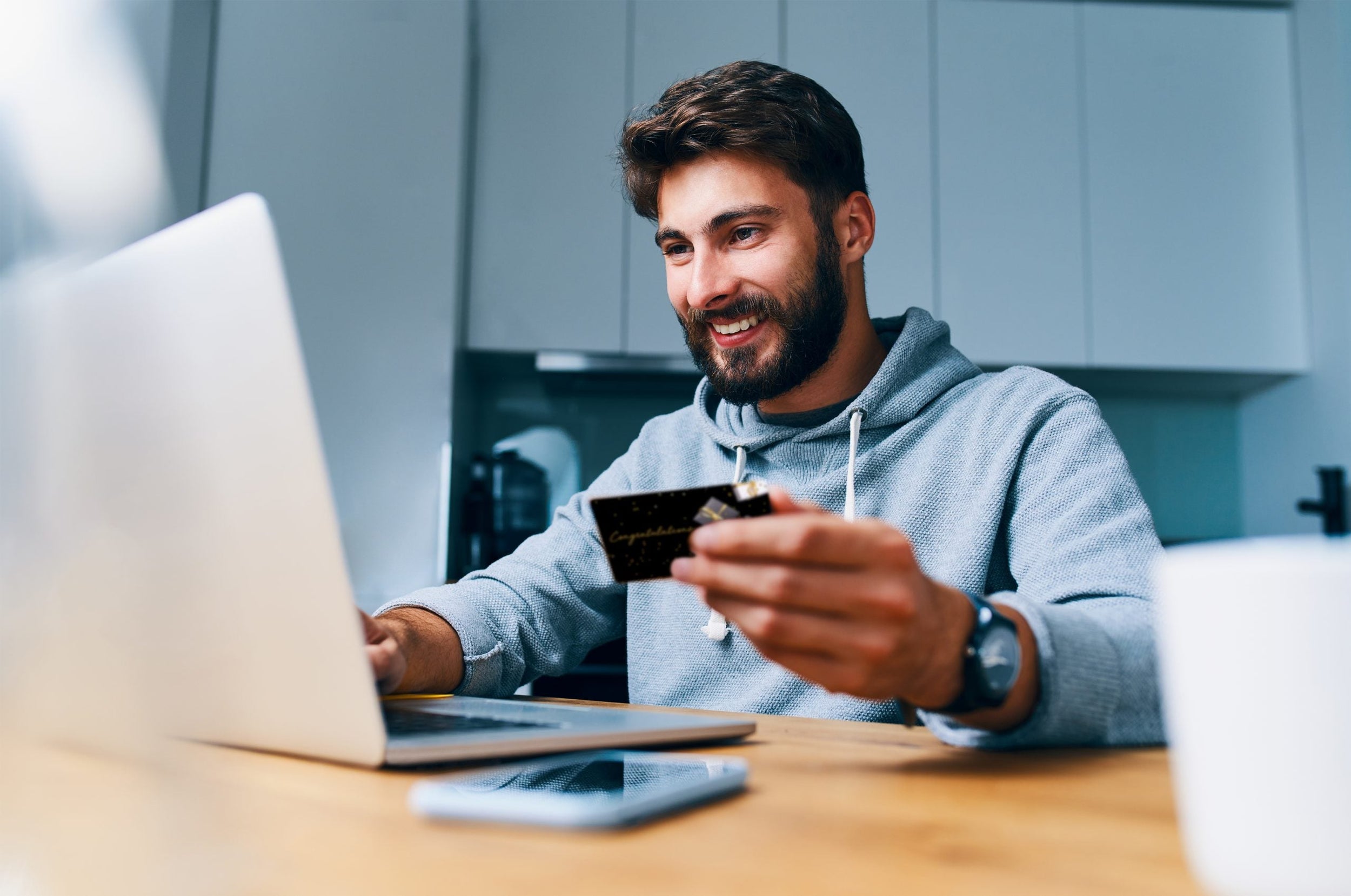 Man using his Congratulations Mastercard Gift Card online via laptop