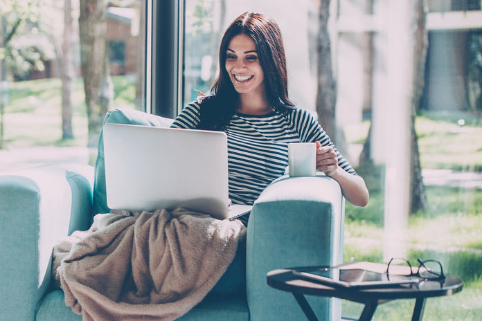 Woman smiling when receiving E-Gift Card on her email. 