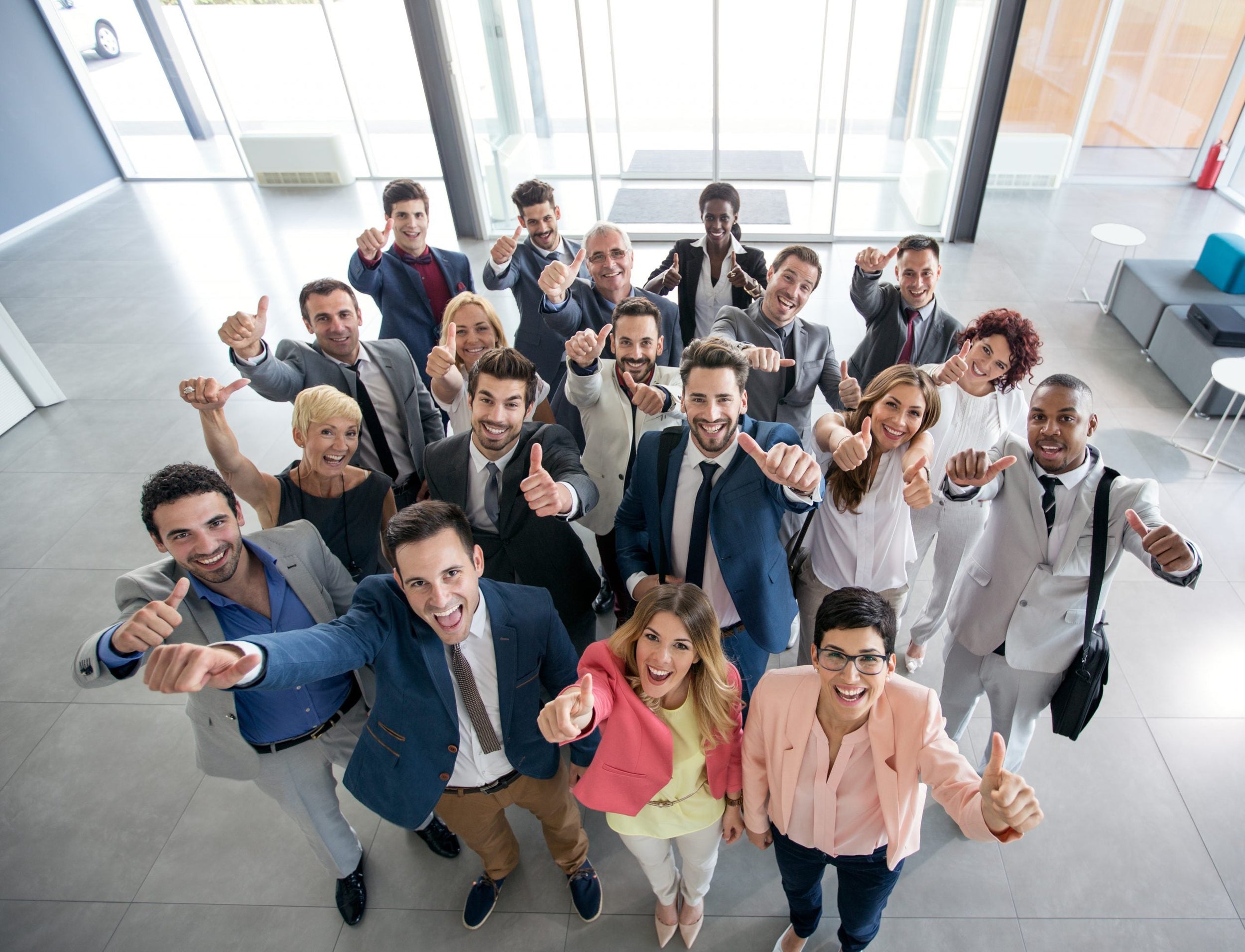 “Professional team group photo of diverse colleagues smiling together in modern office, showcasing workplace collaboration and teamwork.
