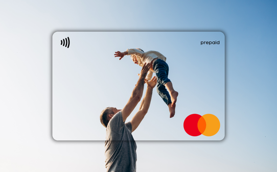 Man holding a child with a Mastercard prepaid card in the foreground