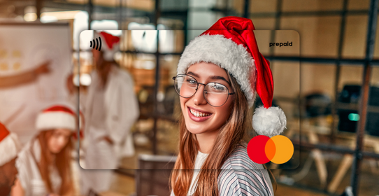 Woman wearing a Santa hat in an office setting featured on a Mastercard Personalised Gift Card 